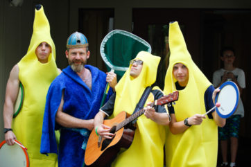 Counselors dressed in banana costumes playing the guitar