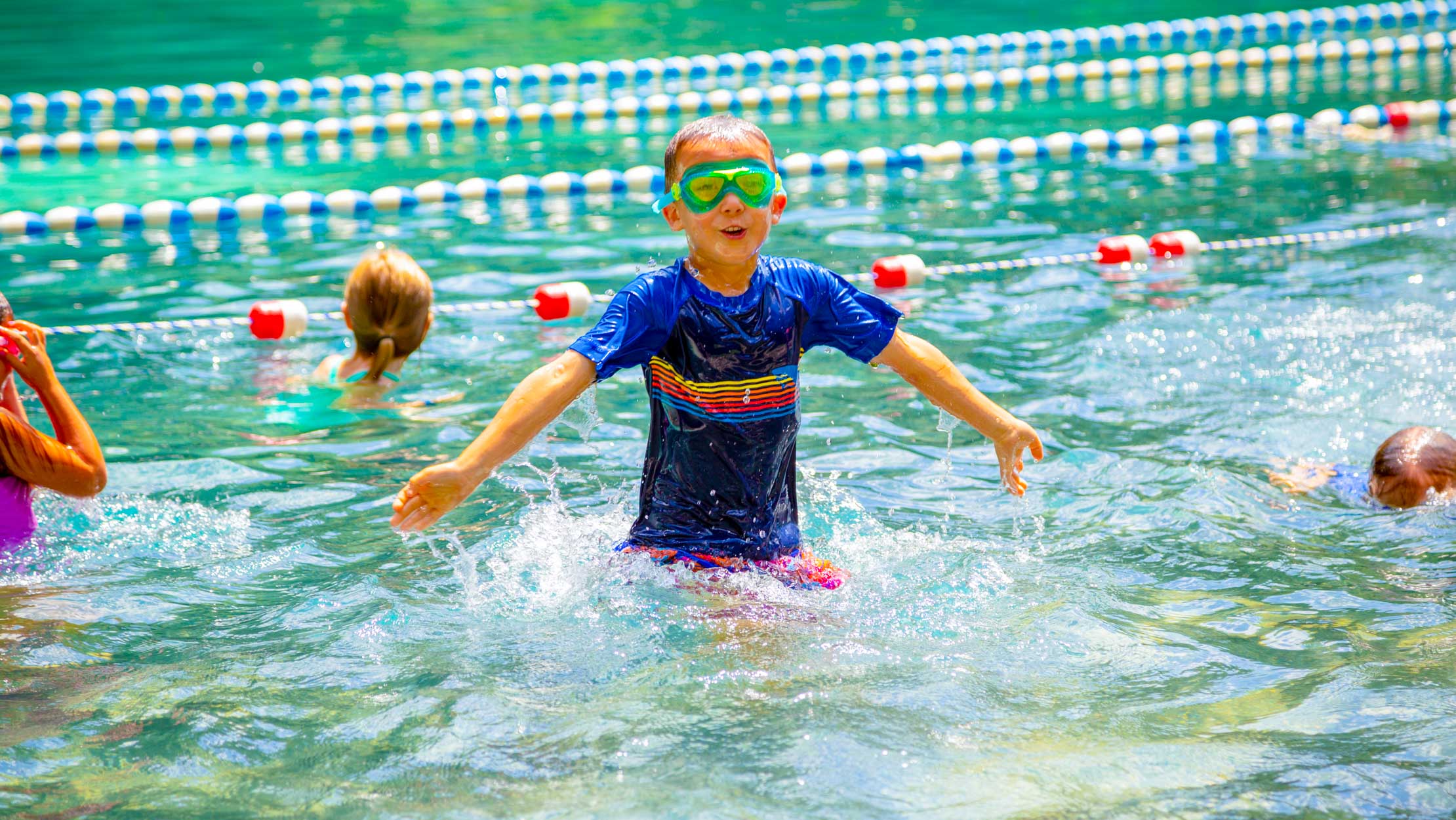 Boy in the pool with goggles