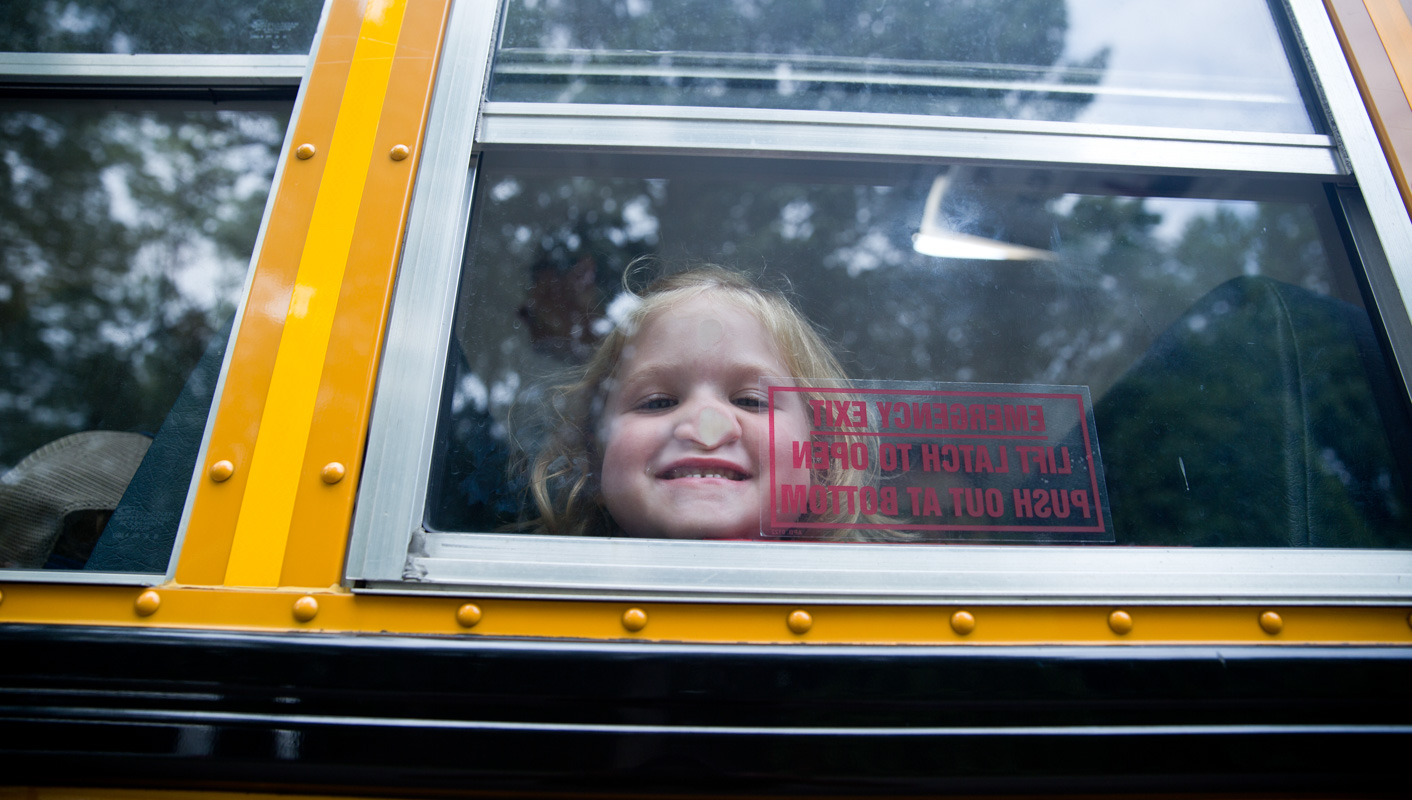Campers pressing her nose against the bus window