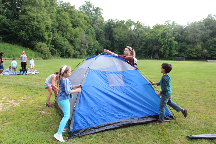Campers putting up a tent