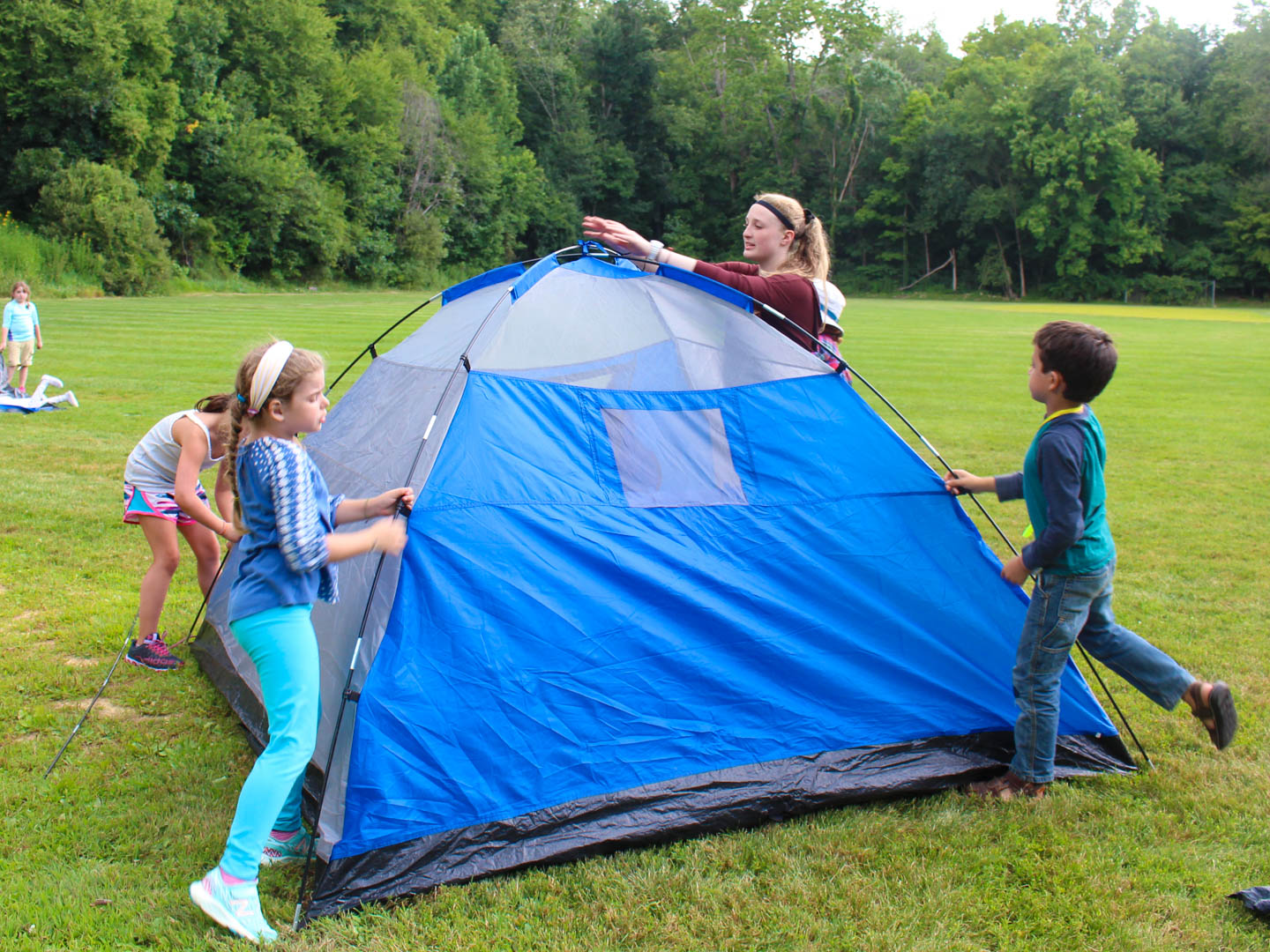 Campers putting up a tent